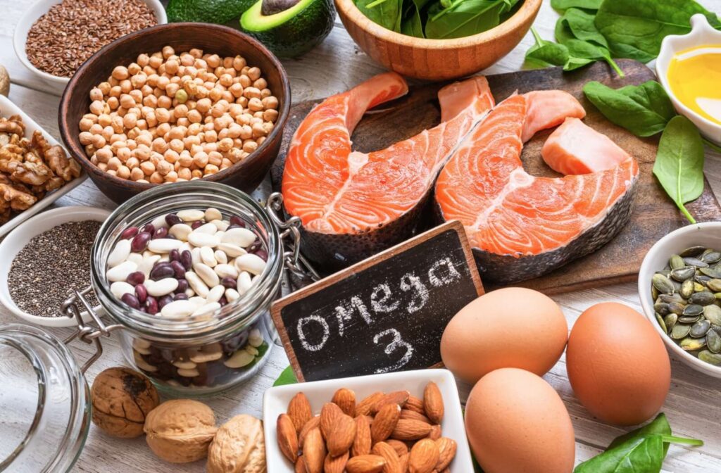 An image displaying severel sources of healthy omega-3s including, fish, nuts, and eggs.